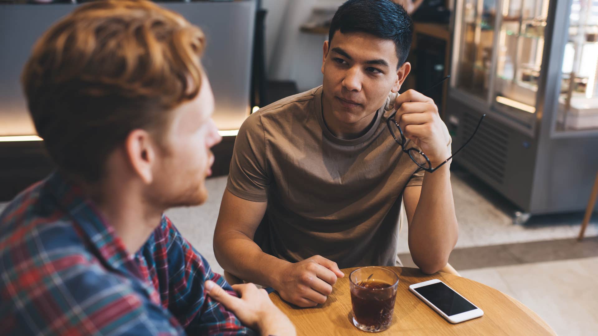 man deflecting vulnerability with humor in a conversation.