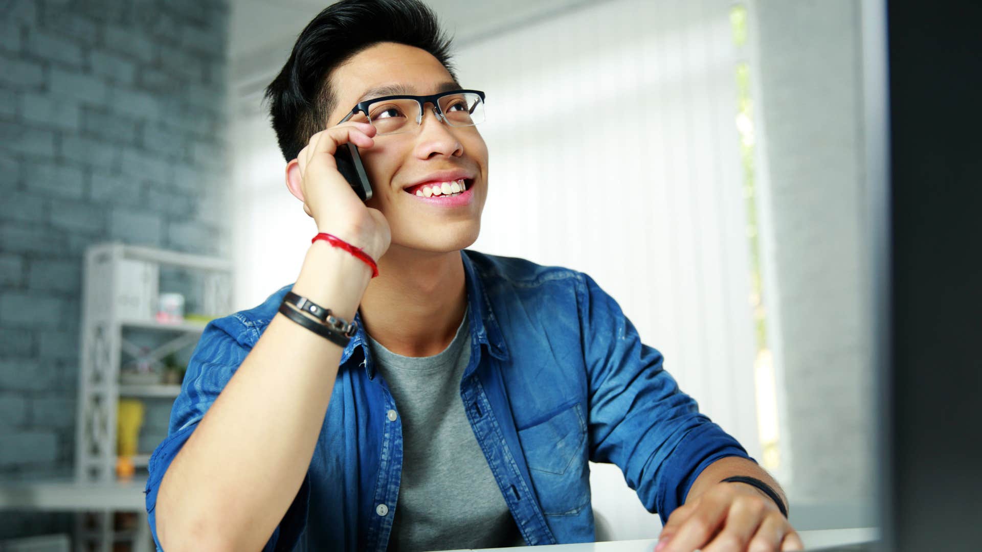 man on the phone talking to his parents about knowing where he belongs