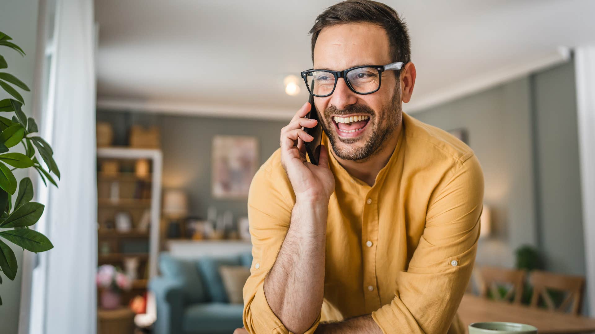 man who respects his past laughing on the phone
