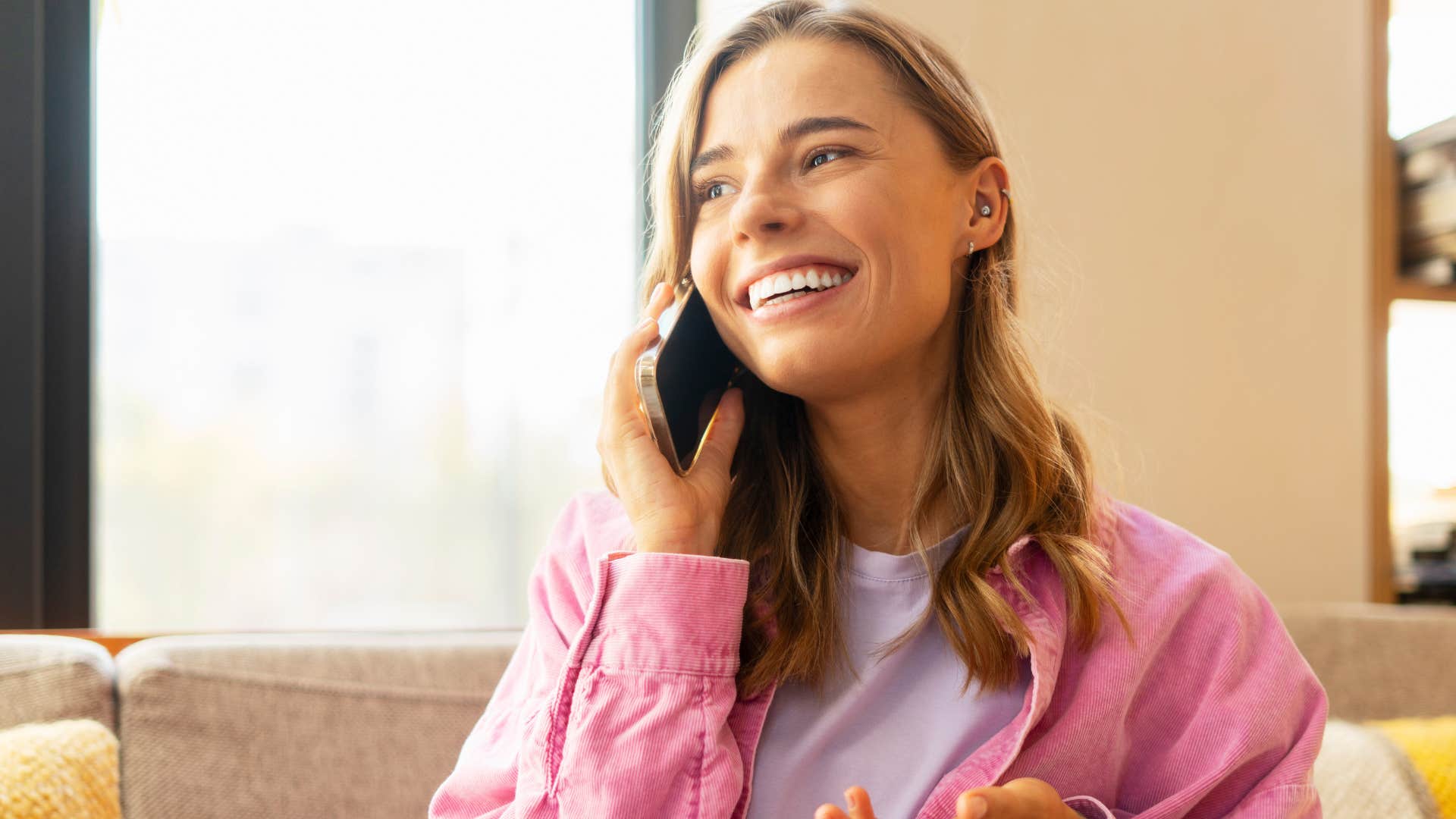 woman who sees her parents as people too smiling on the phone talking to them