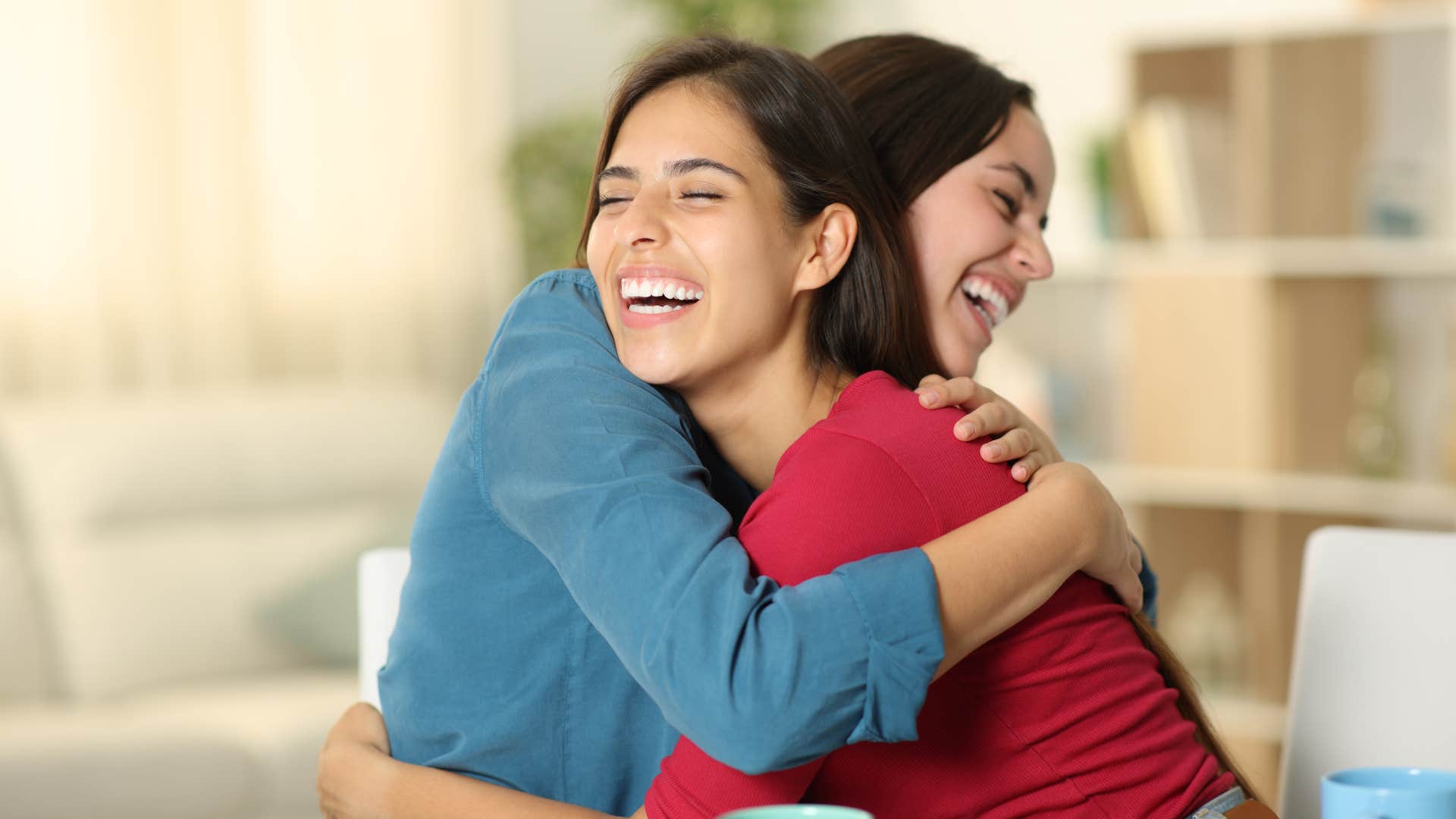 friends hugging as their reactions seem forced