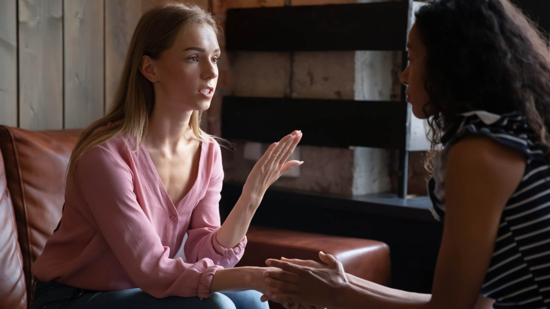 unhappy woman excessively apologizing to friend