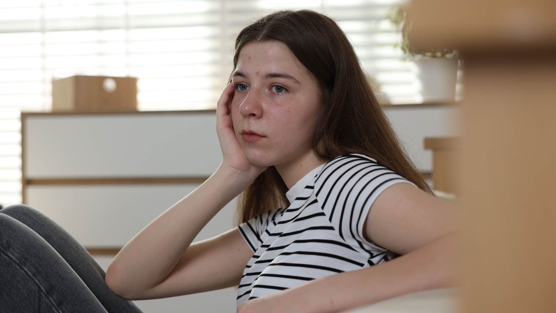 sad young woman comparing herself to others