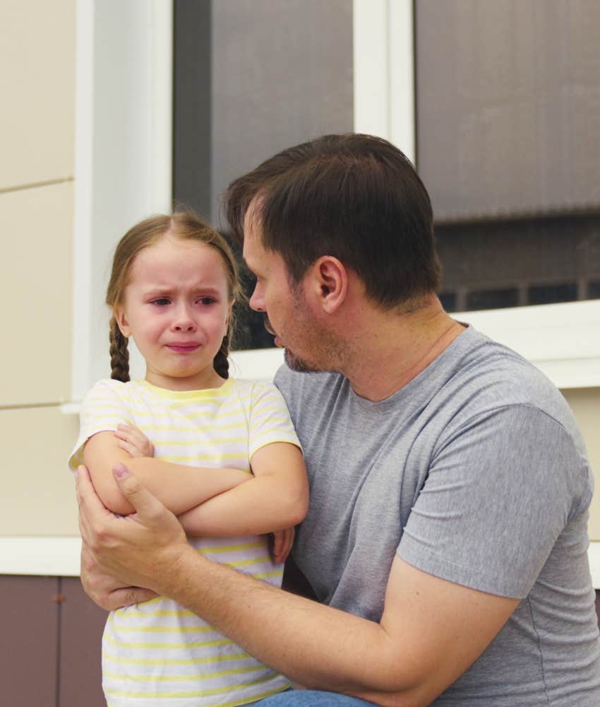 Crying daughter and supportive father showing fear of mean girls