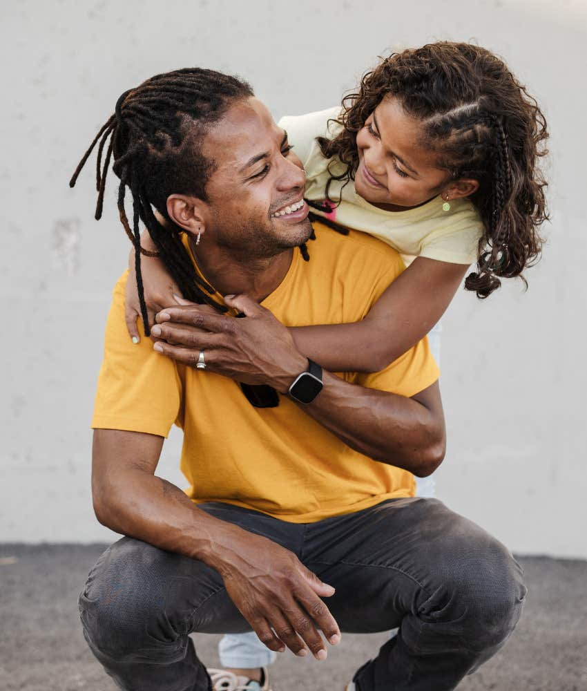 Loving father and daughter hug showing protection 