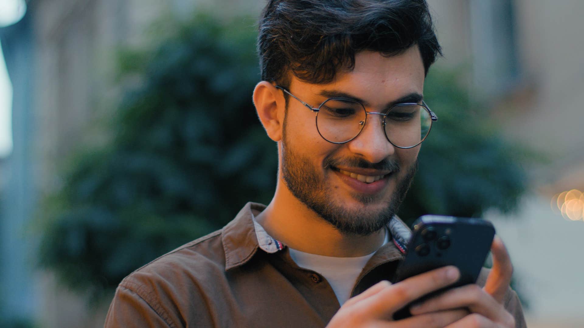 young man researching on TikTok from his phone