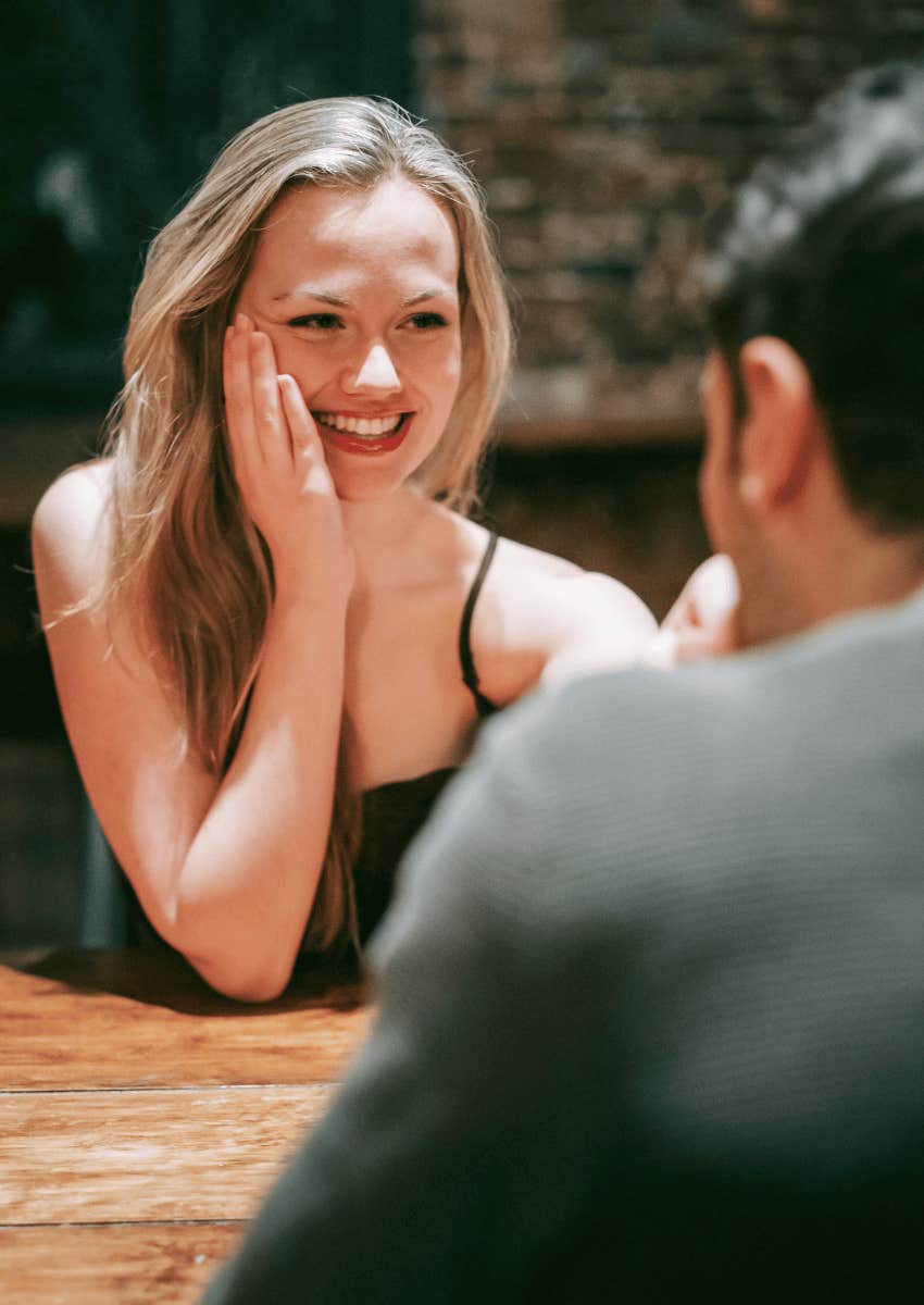 bashful woman being flirted with by man