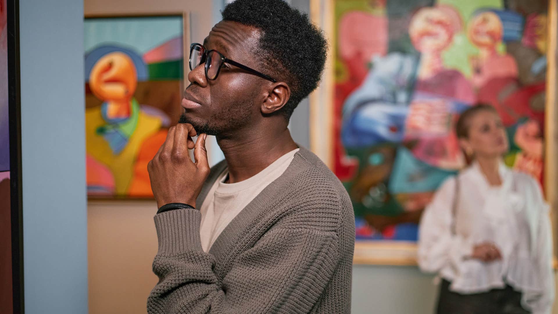 man with a deeply feeling mind at a museum appreciating art on a deep level