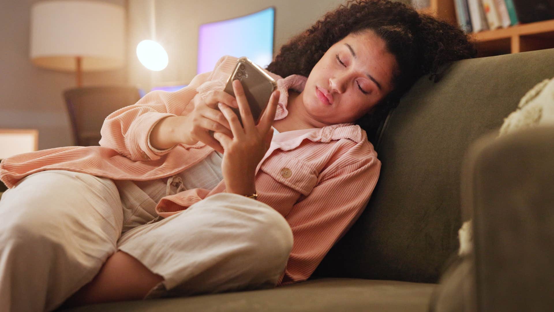 tired woman canceling plans texting mine bones creaketh, my soul doth sigh, I musn't attend