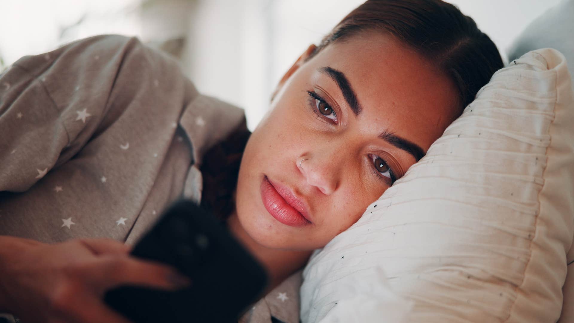 tired woman in bed canceling plans texting a plague of fatigue hath beset me