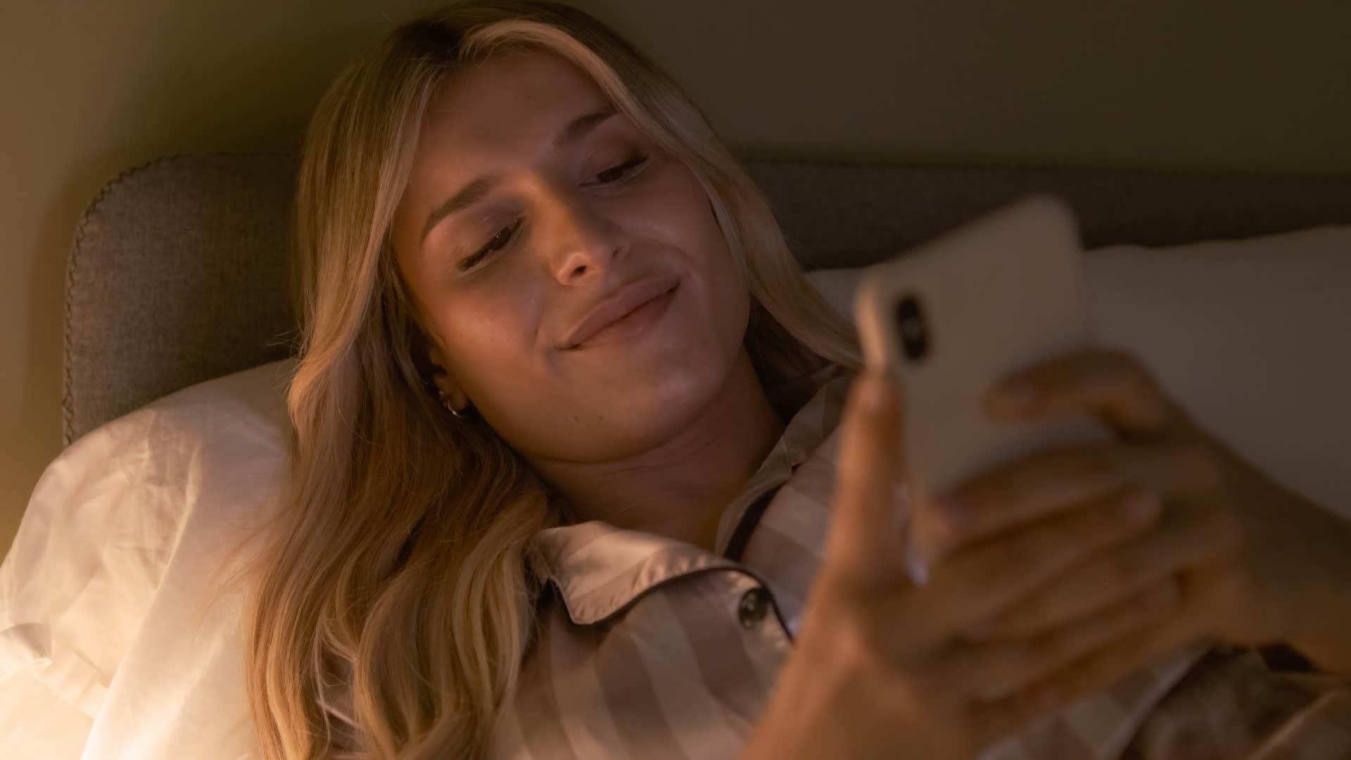 smiling woman texting I am summoned by duties most grave, mine bed