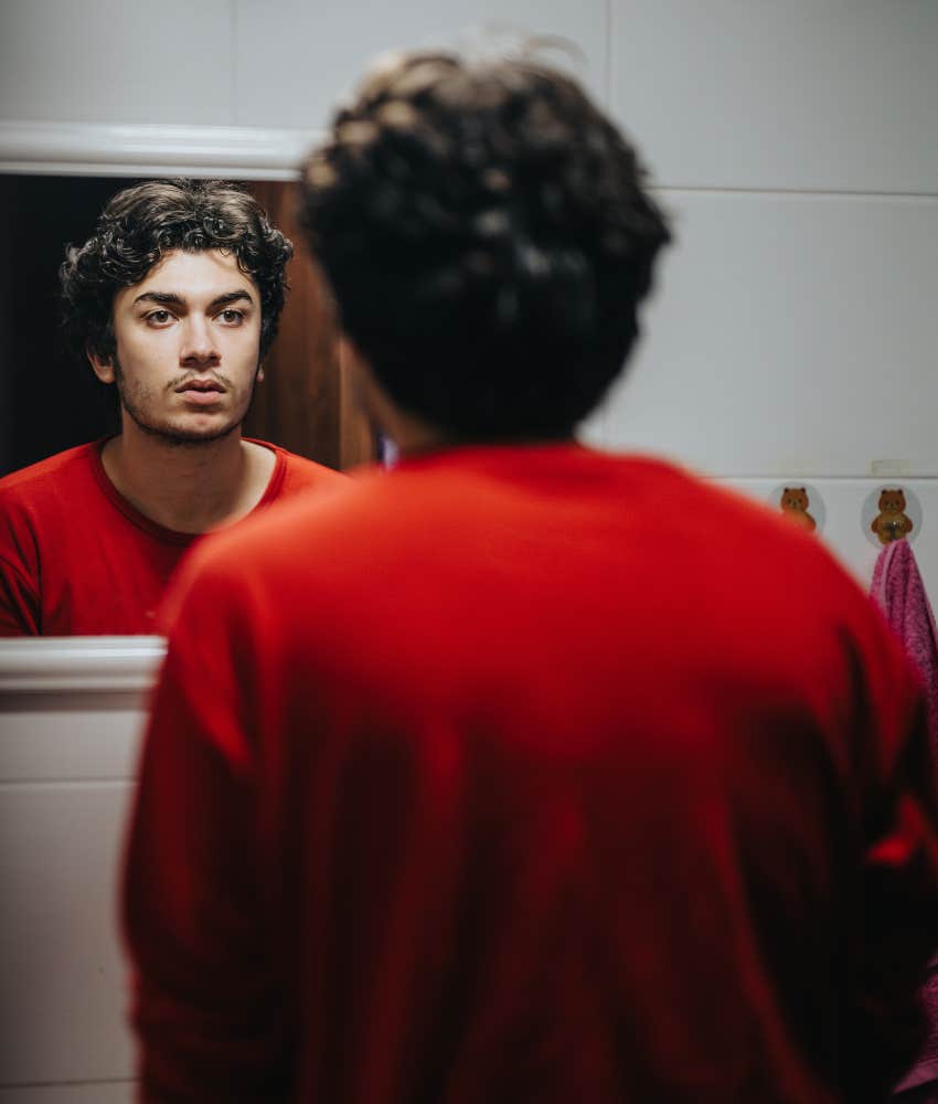 Serious person looks in mirror to name inner critic showing way for less stress