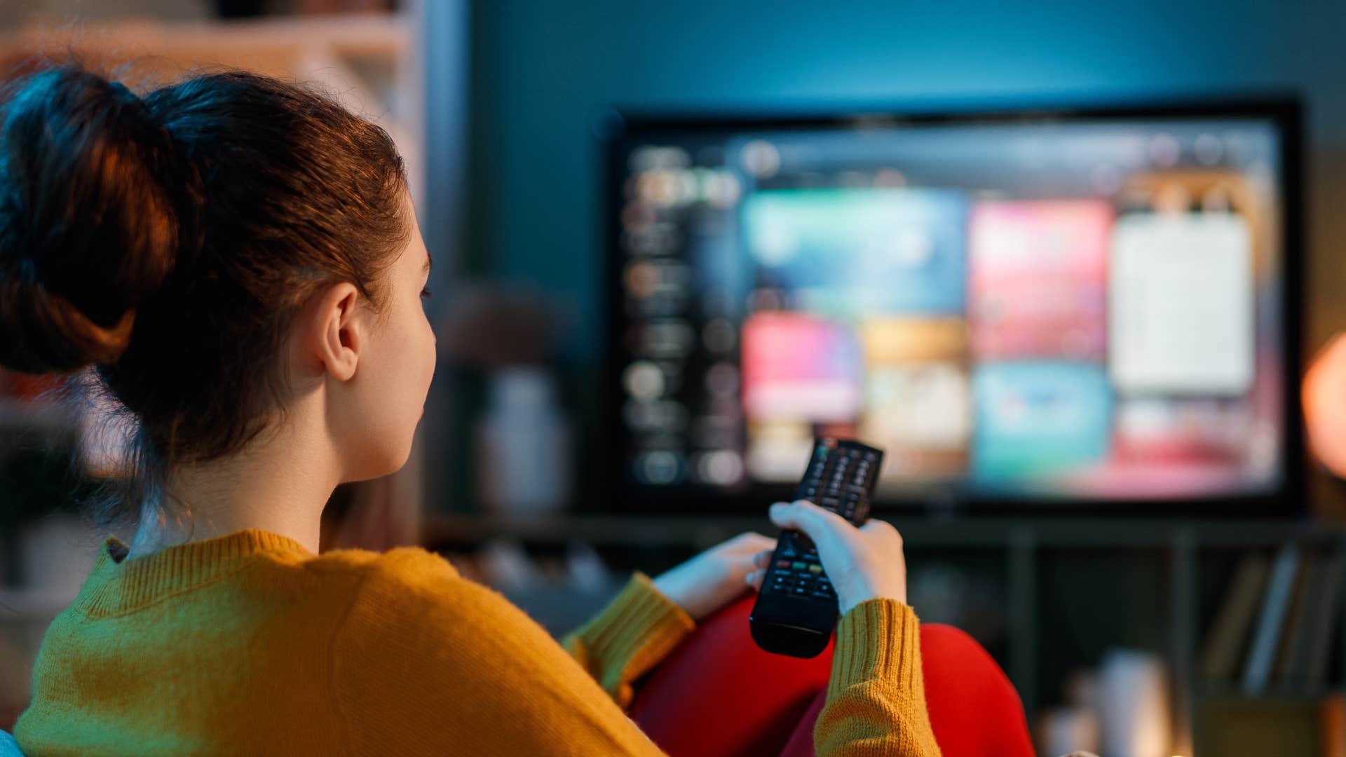 woman flipping through tv channels for background noise