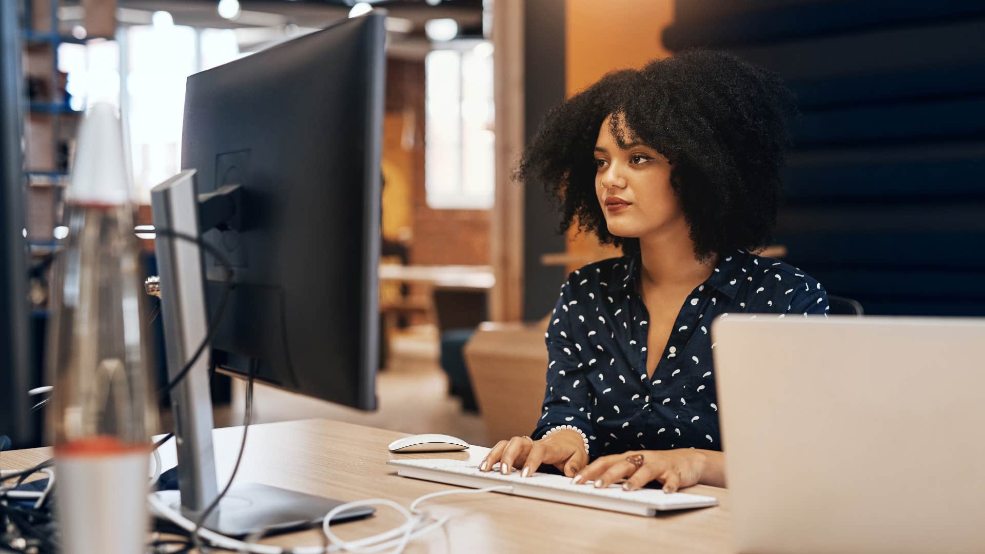 woman tapping her keyboard in a quiet environment