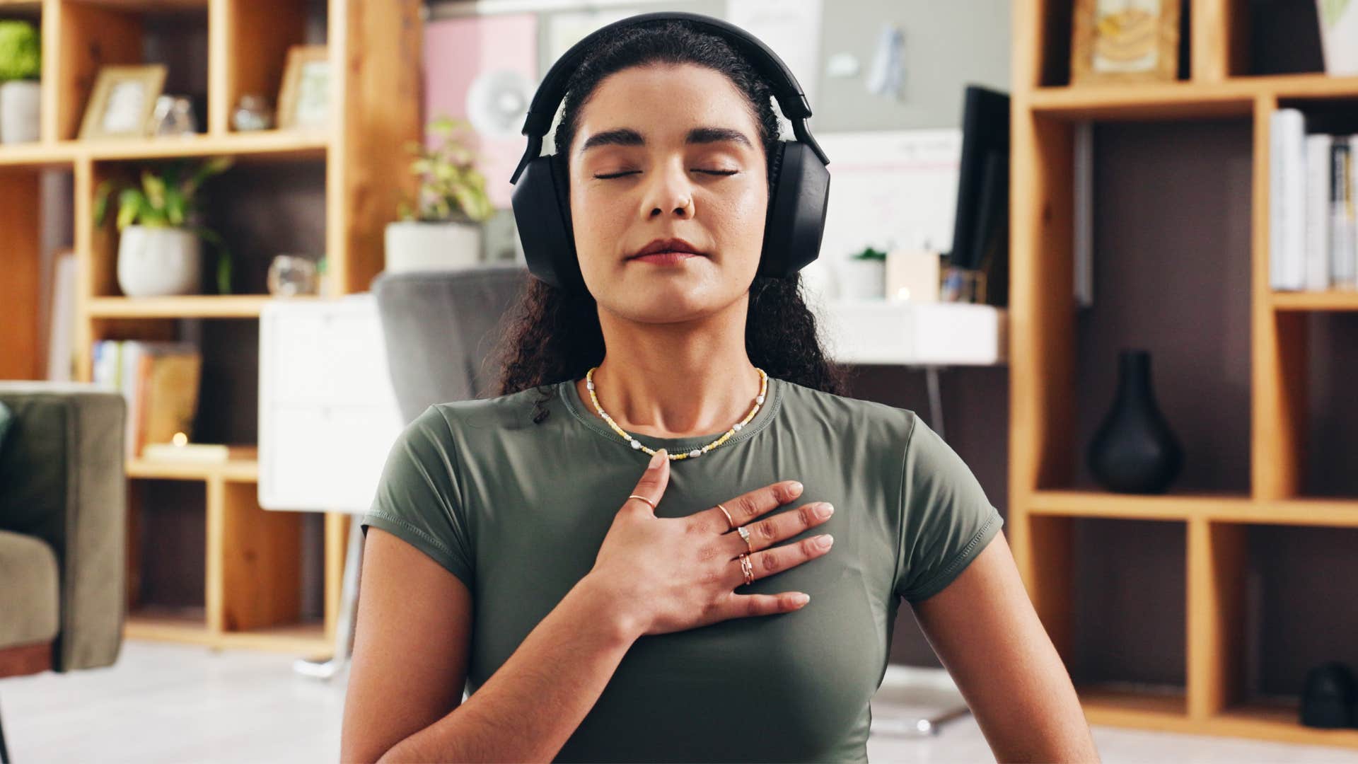 woman with headphones in breathing during meditation