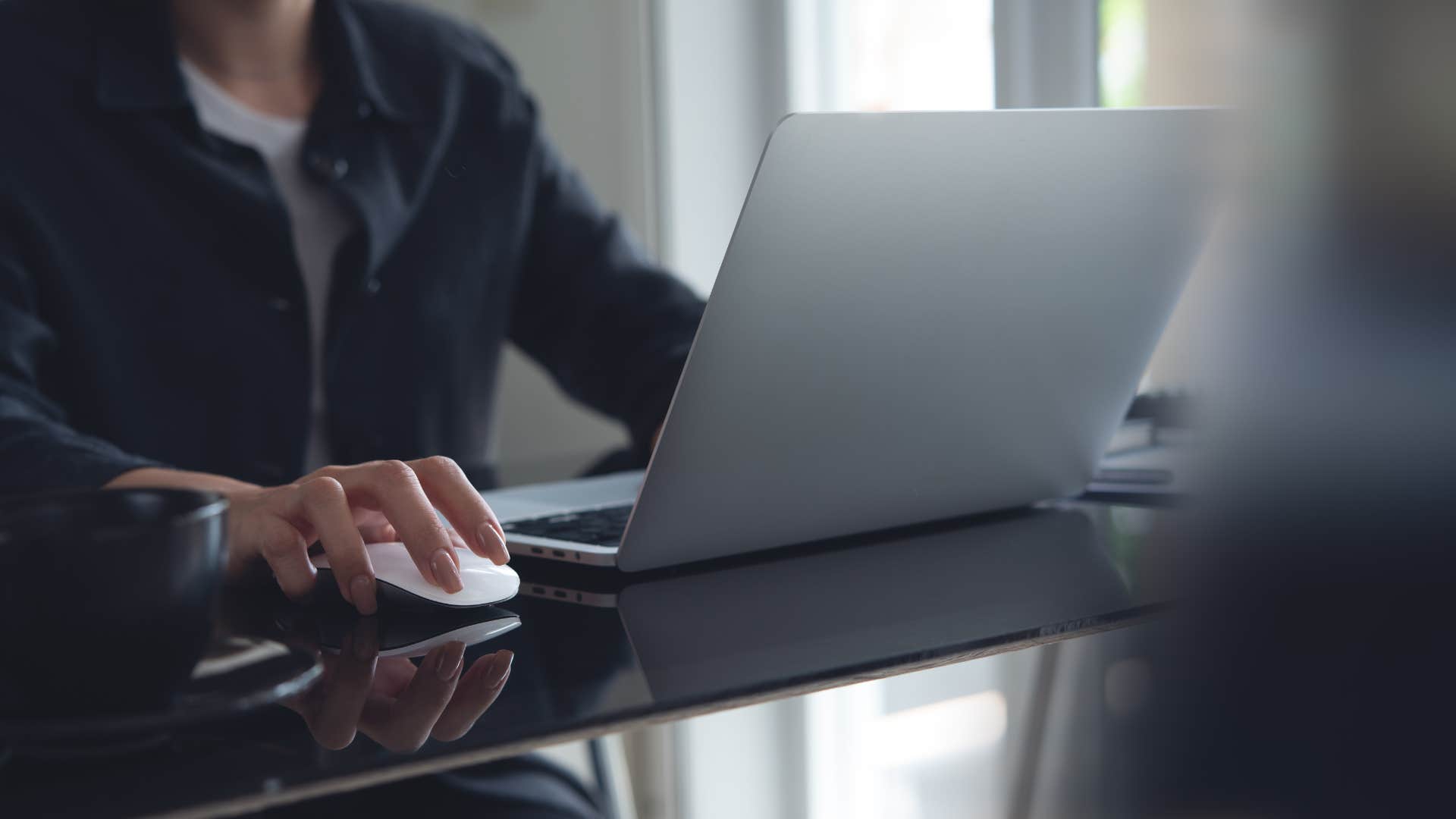 man clicking his mouse repeatedly as he works
