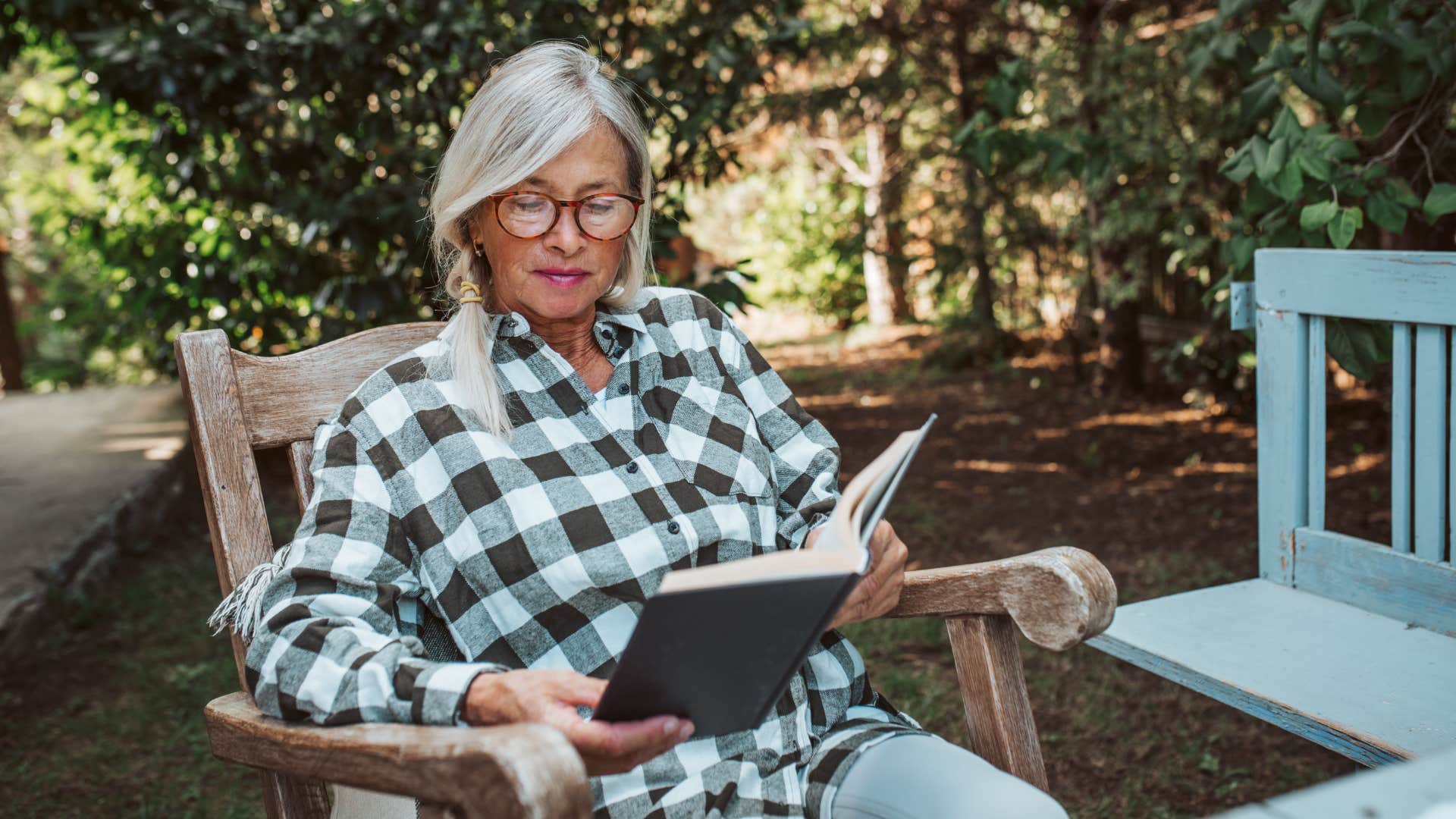 Older person reads book showing daily habit to keep mind active