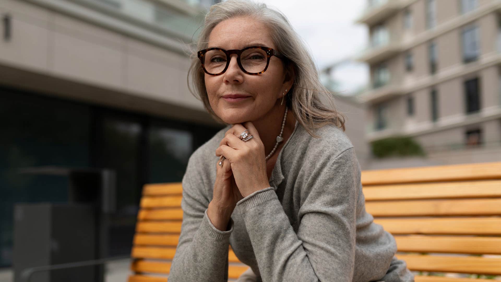 Woman who's quiet in conversations sitting outside.