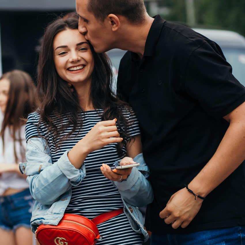 man dressed casually while out with his dressed up girlfriend