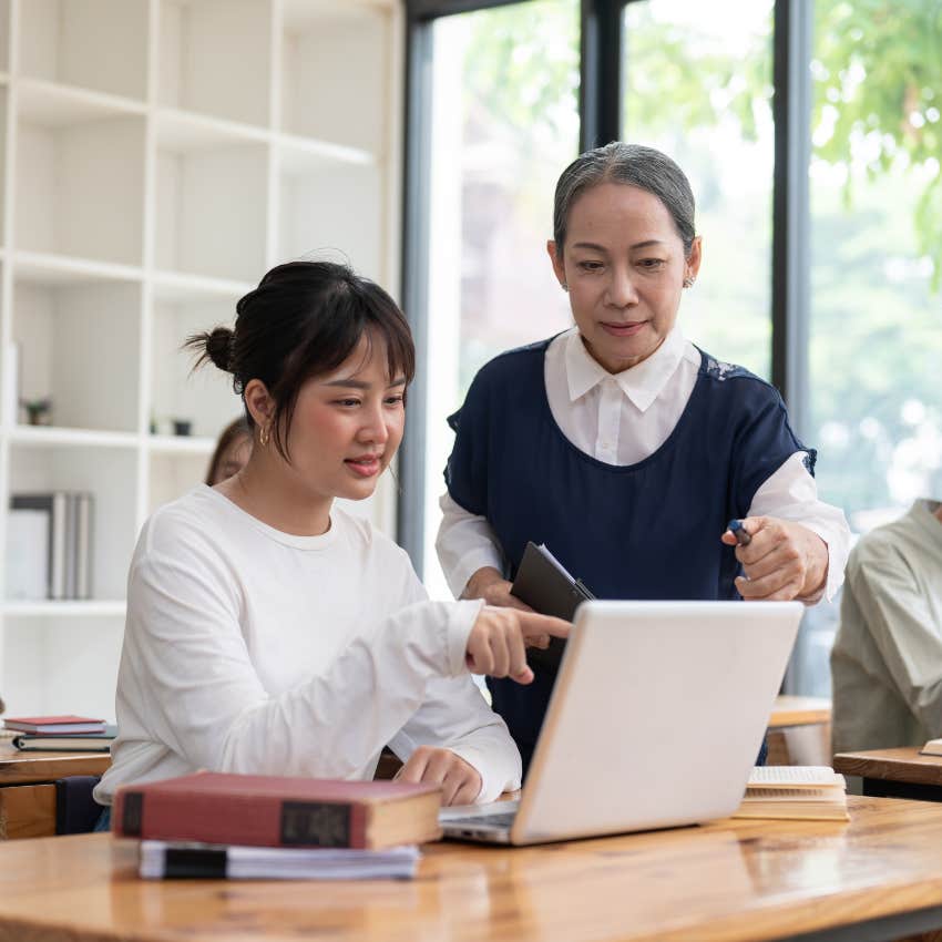 teacher helping female student learn career skills