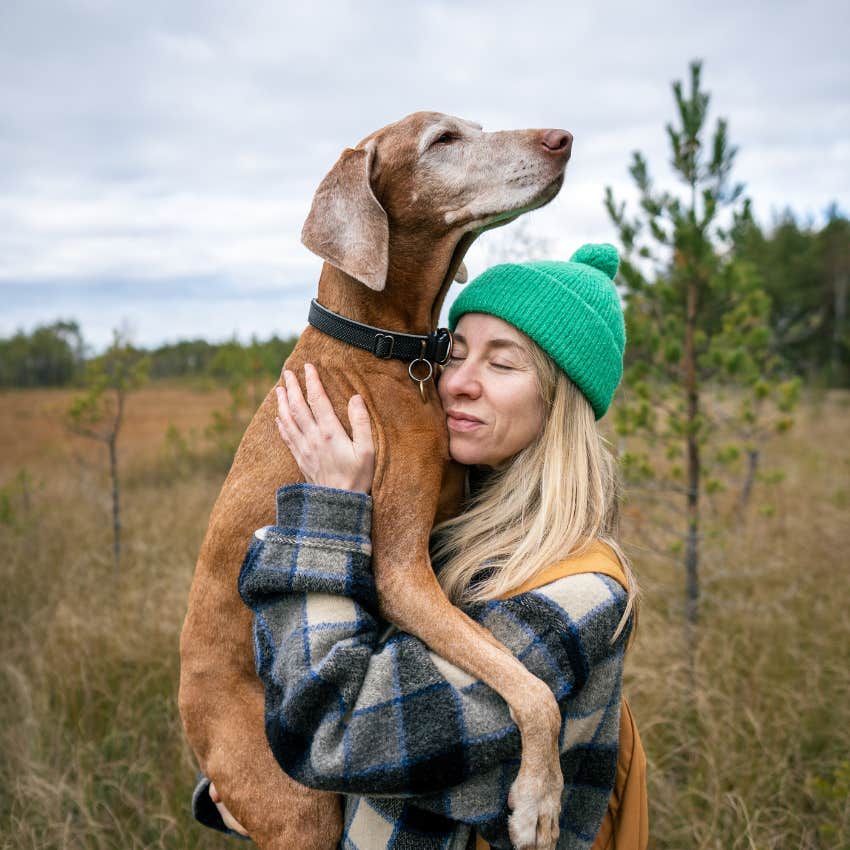woman holding her dog ages faster than originally thought updated scientific equation