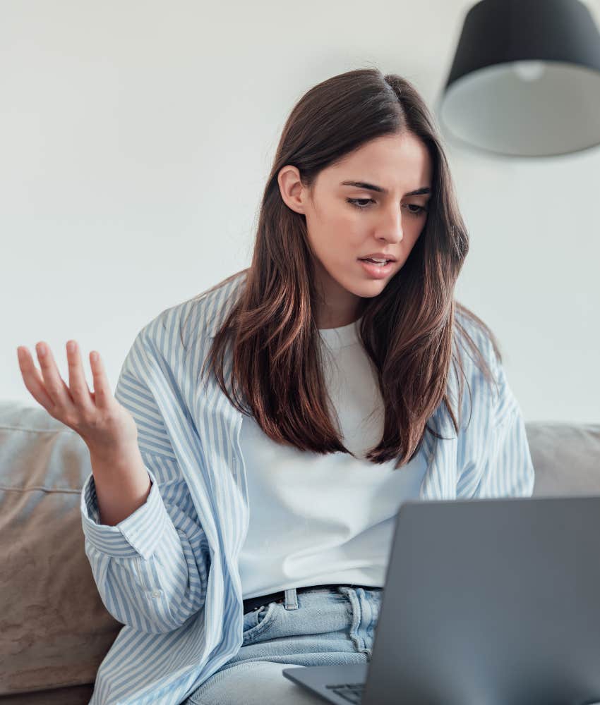 woman surprised reading email on laptop rejected from job over people pleasing