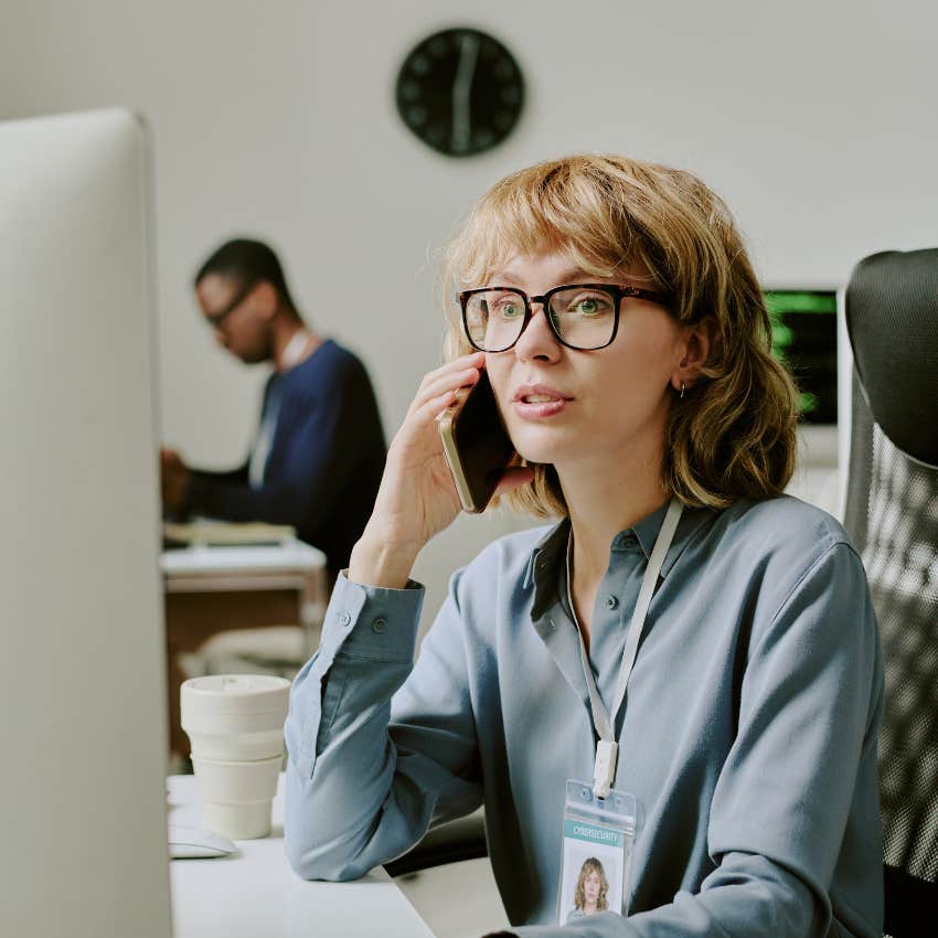 woman looking at her monitor at work with graveyard of former co-workers
