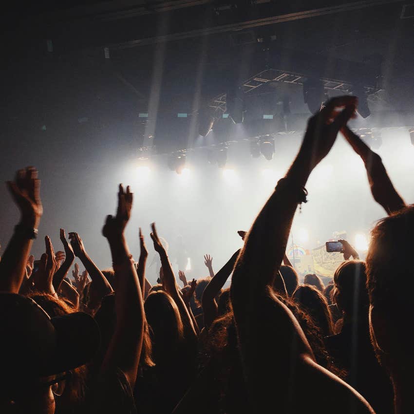 fans having fun at a concert despite views blocked by cameras