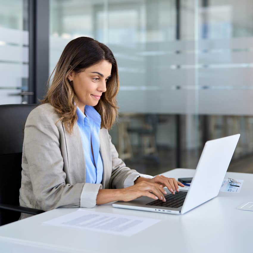 woman typing message on laptop