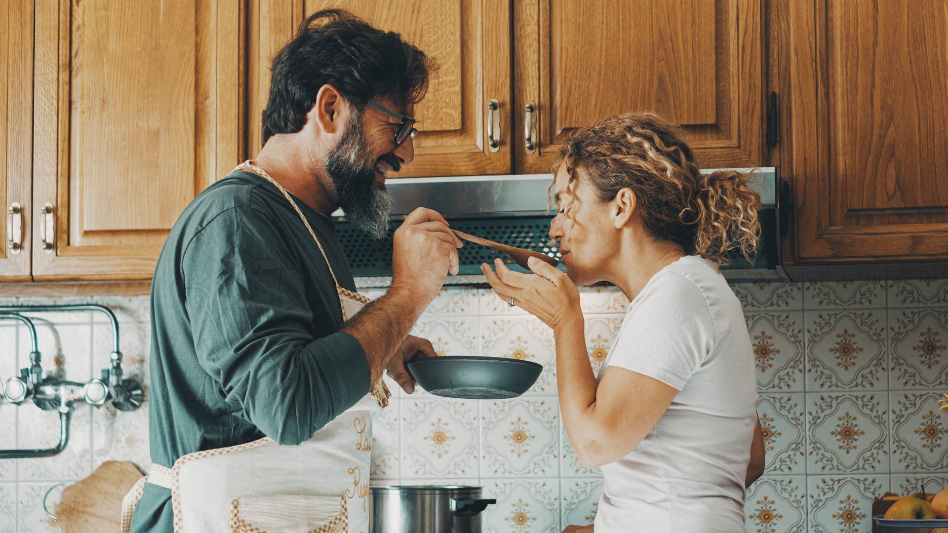 Attentive person cooks for partner showing way to make happier relationship