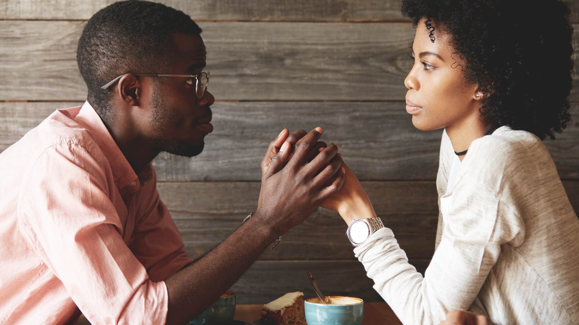 Undistracted couple hold hands sowing way to make relationship happier