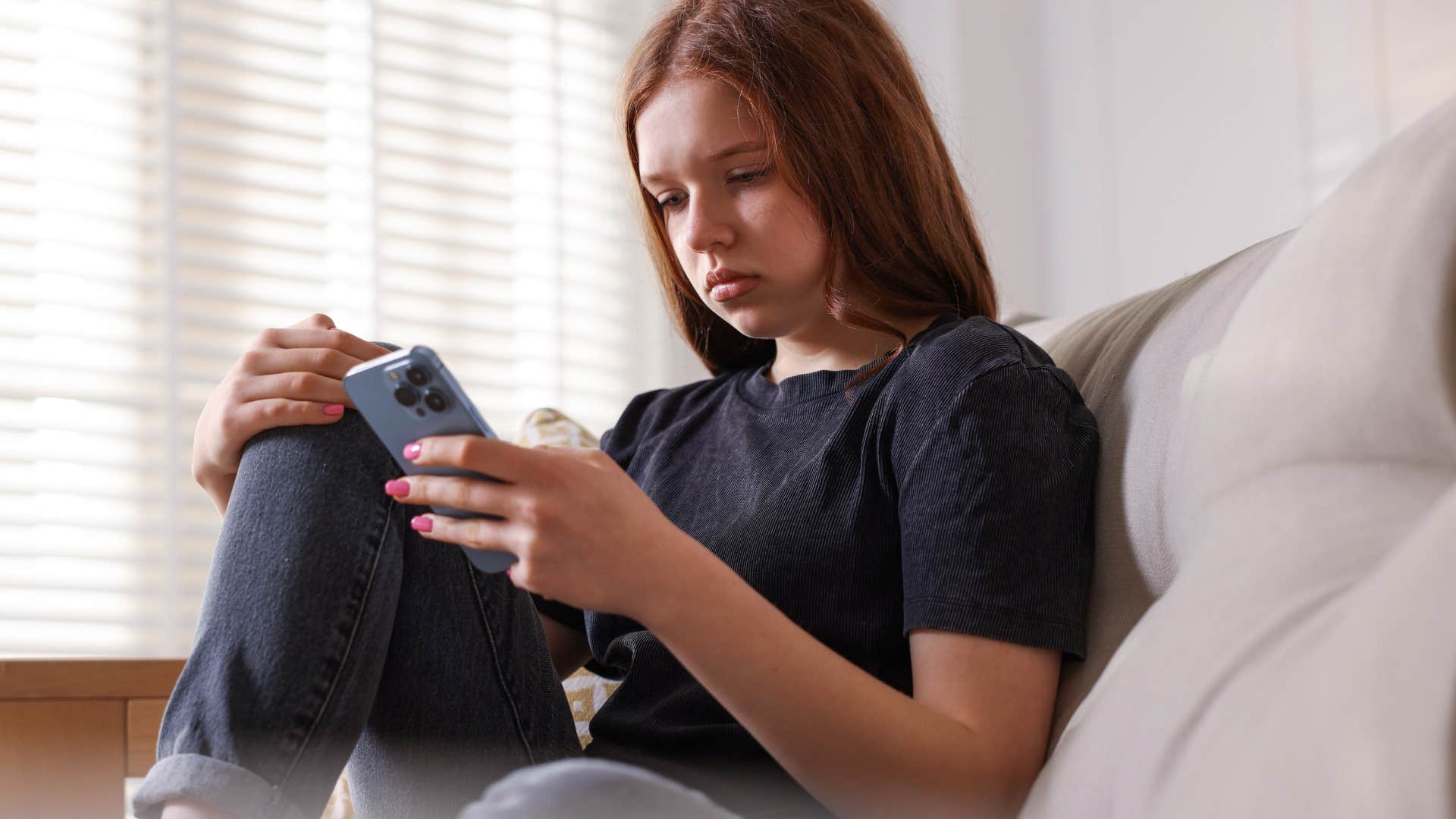 Gen Z woman is exhausted by the news on her phone 