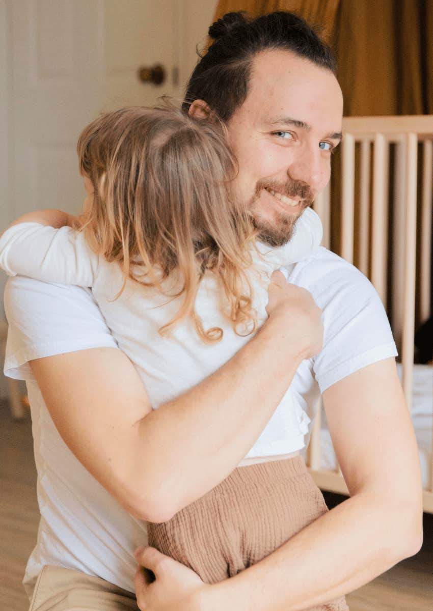 genuine man hugging a child