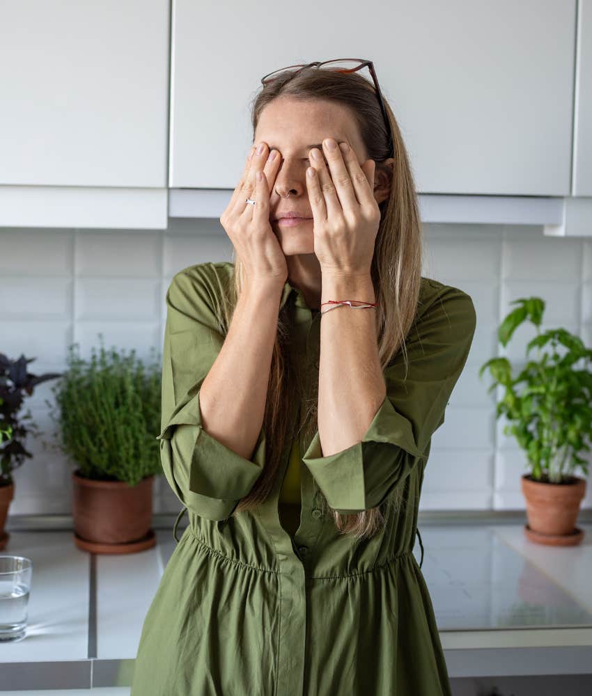 Exhausted person covers face with hands showing extreme of getting over ex