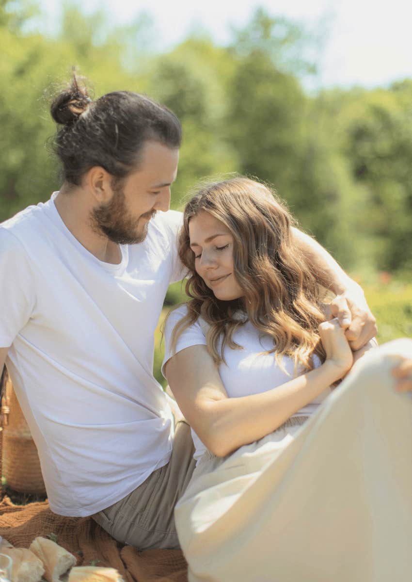 happy couple sitting close outdoors