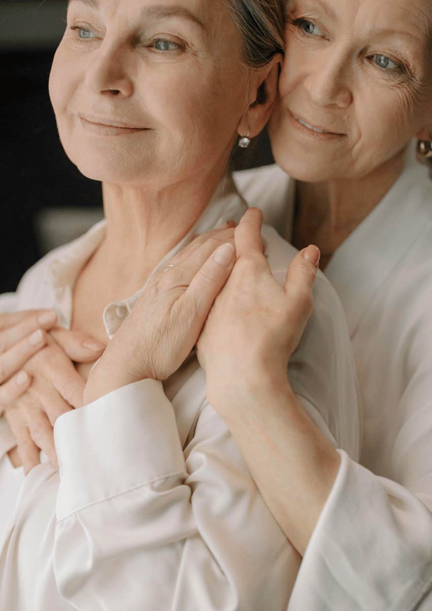 happy female couple hugging each other close