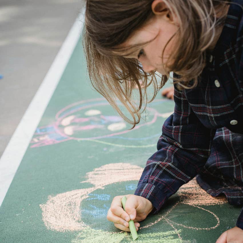 little girl playing with chalk