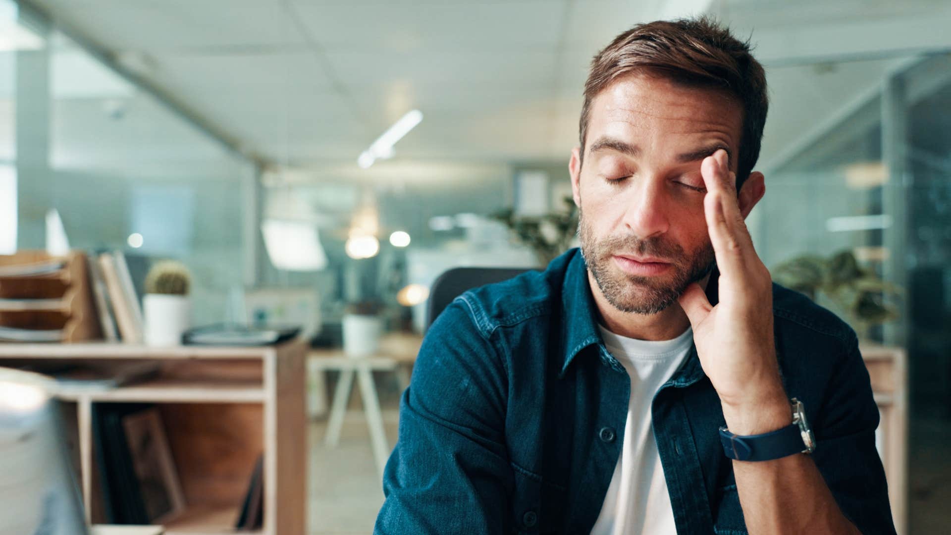 man rubbing head as he thinks i'm tired of arguing with you
