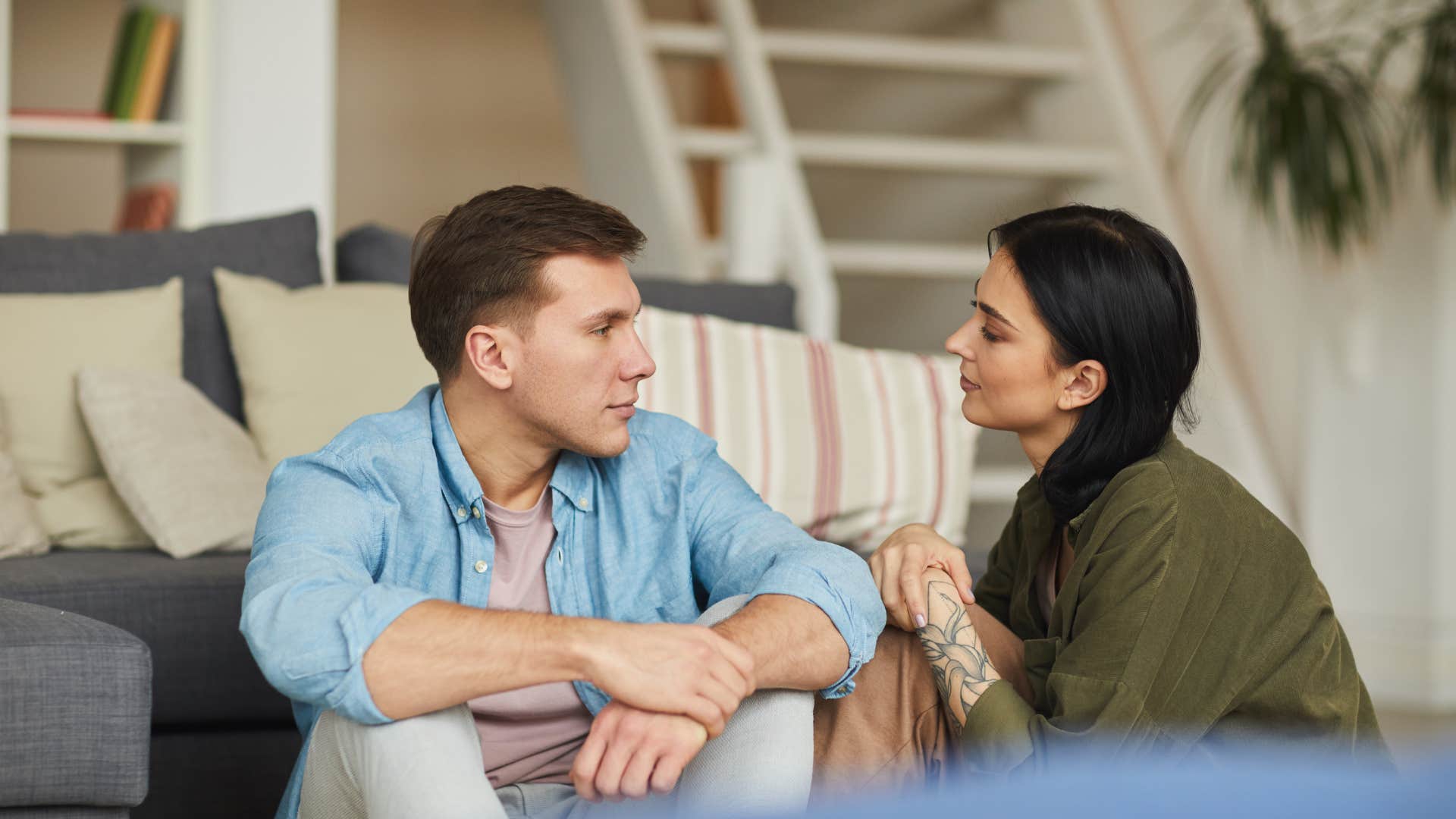 young couple talking while sitting on the floor