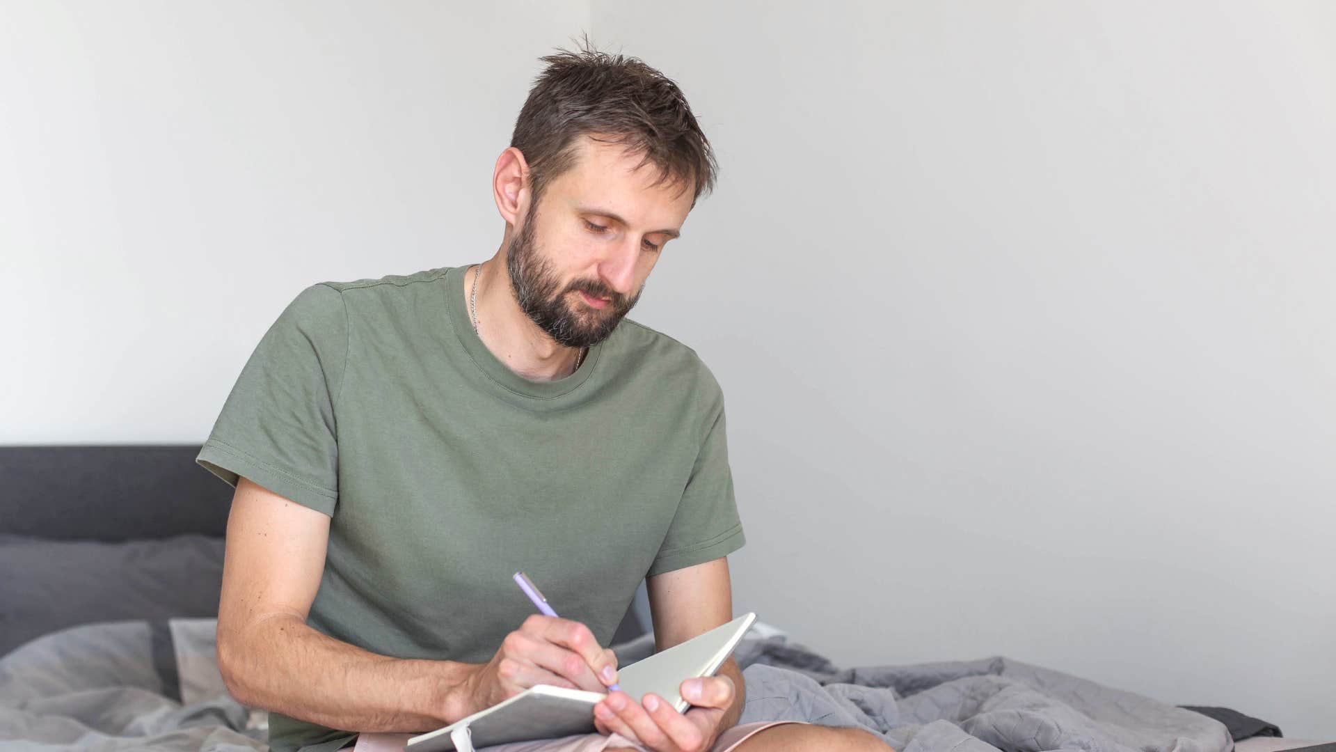 man writing note