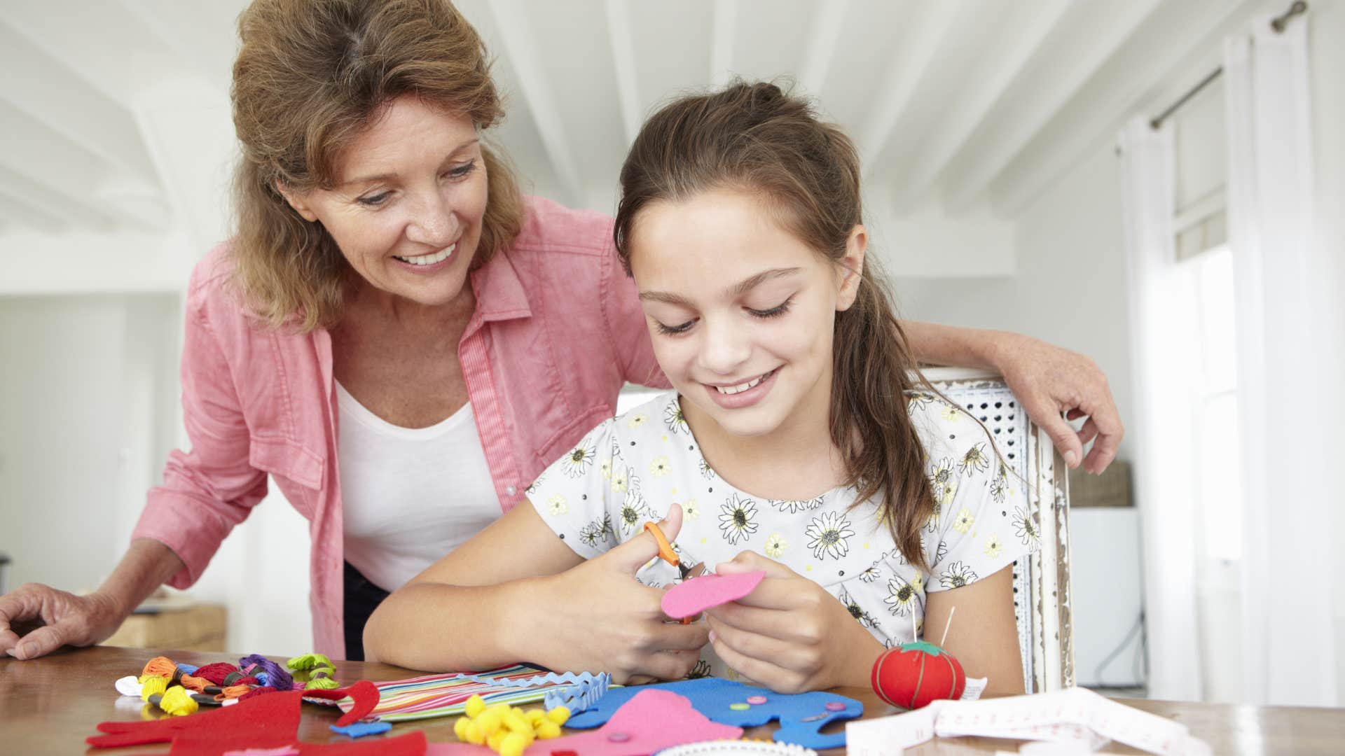 young girl doing handicrafts with grandmother