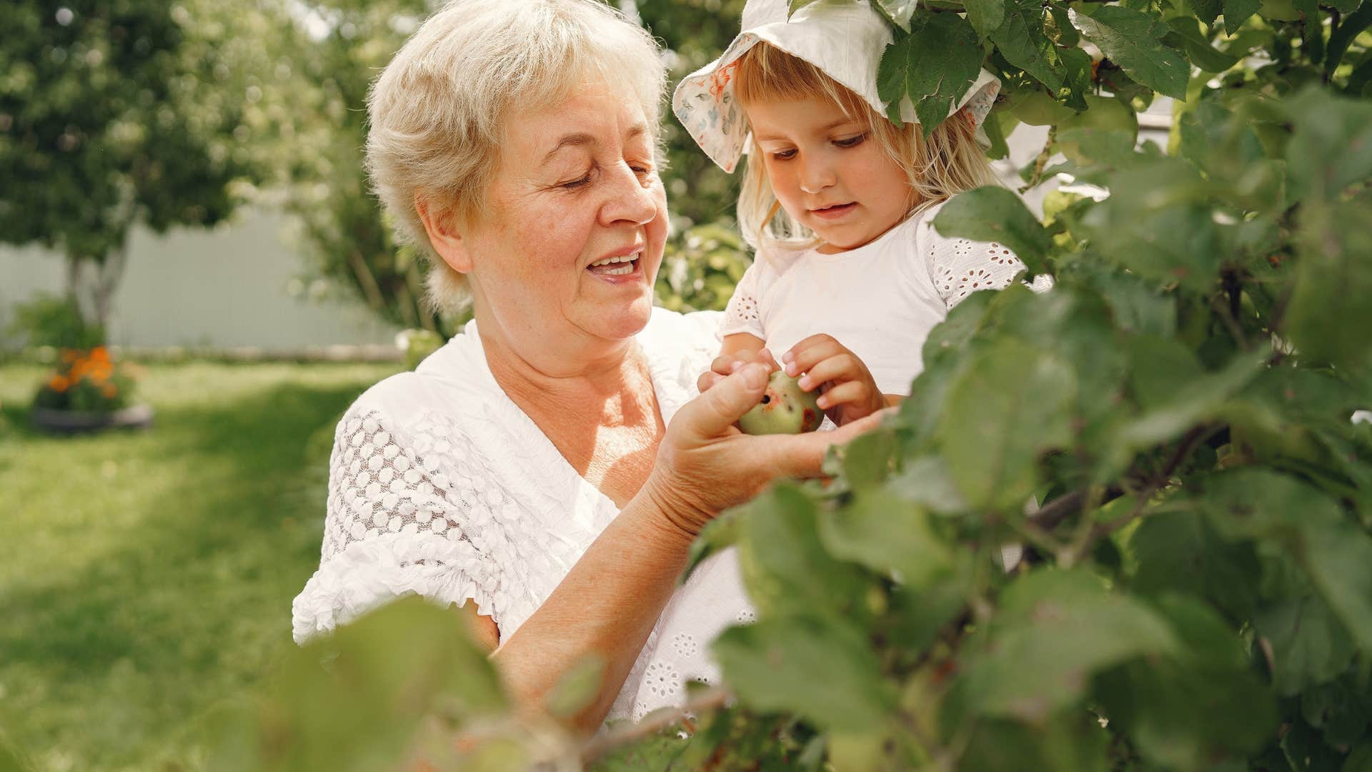 grandma gardening with grandchild outside