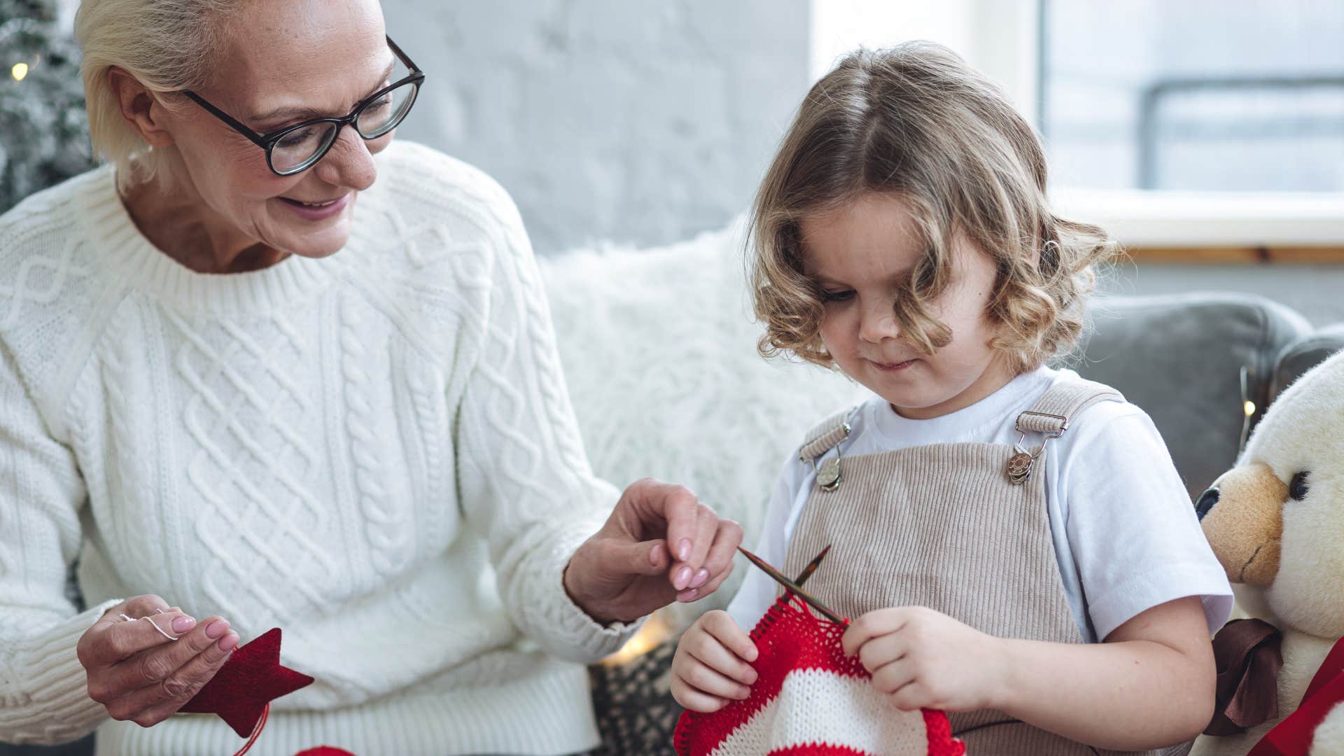 grandma helping granddaughter sew