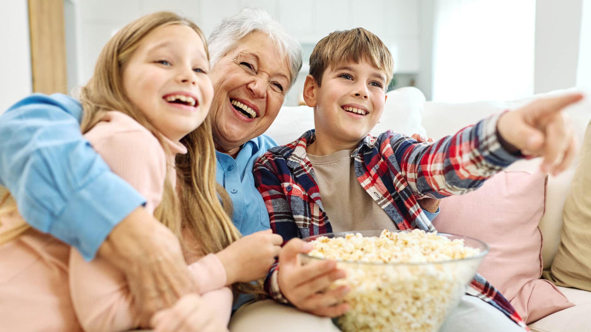 grandma watching movies on couch with grandkids