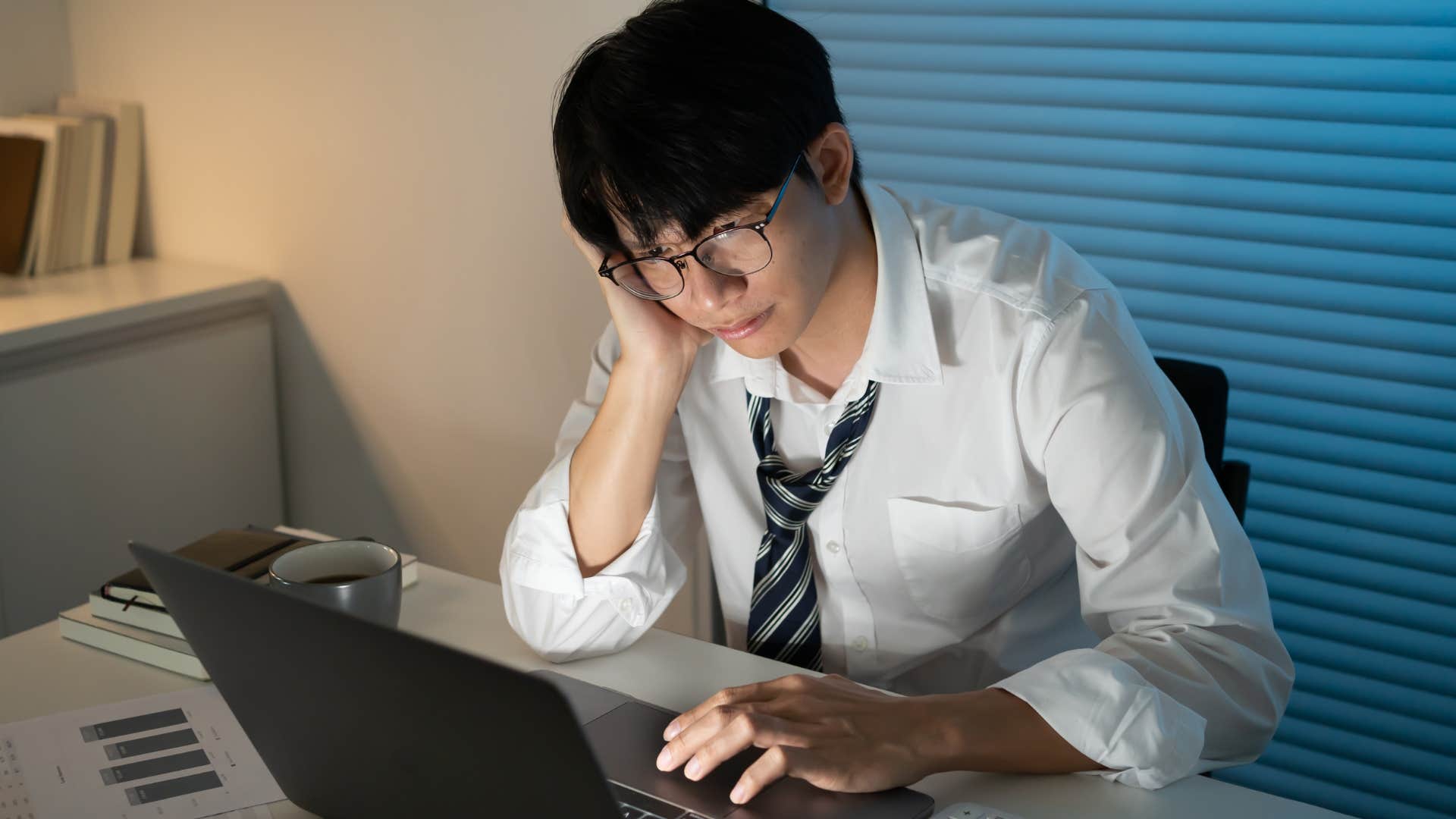 man relying on busyness as a distraction working late