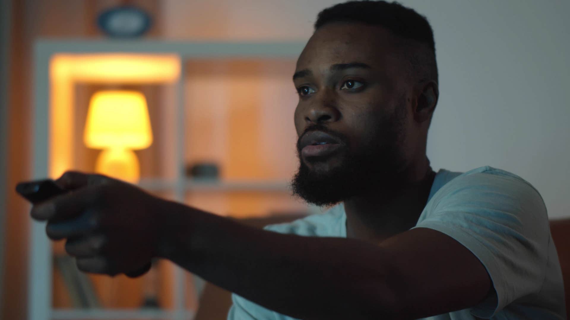 lonely man with no close friends watching comfort movies and TV shows