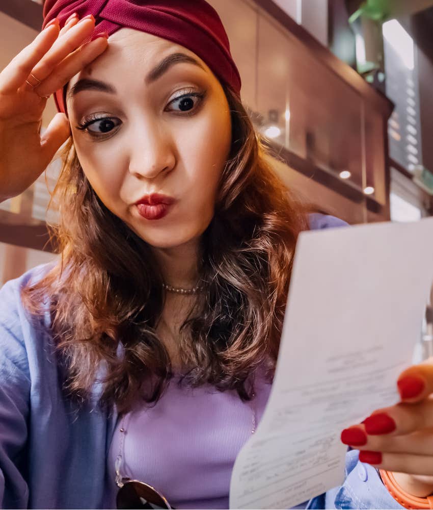 Dissatisfied person looks at receipt showing struggle more about money