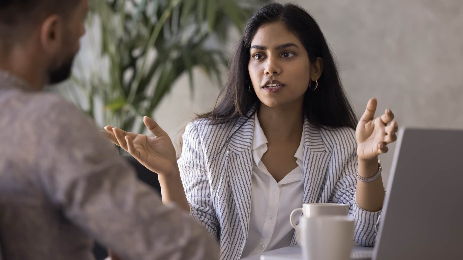 open-minded woman talking to colleague at work