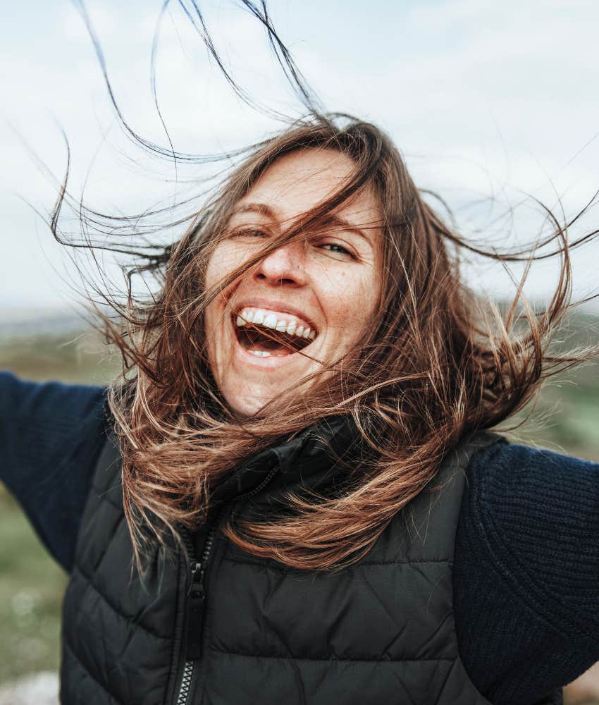 Joyous person with wind in hair showing love of everything