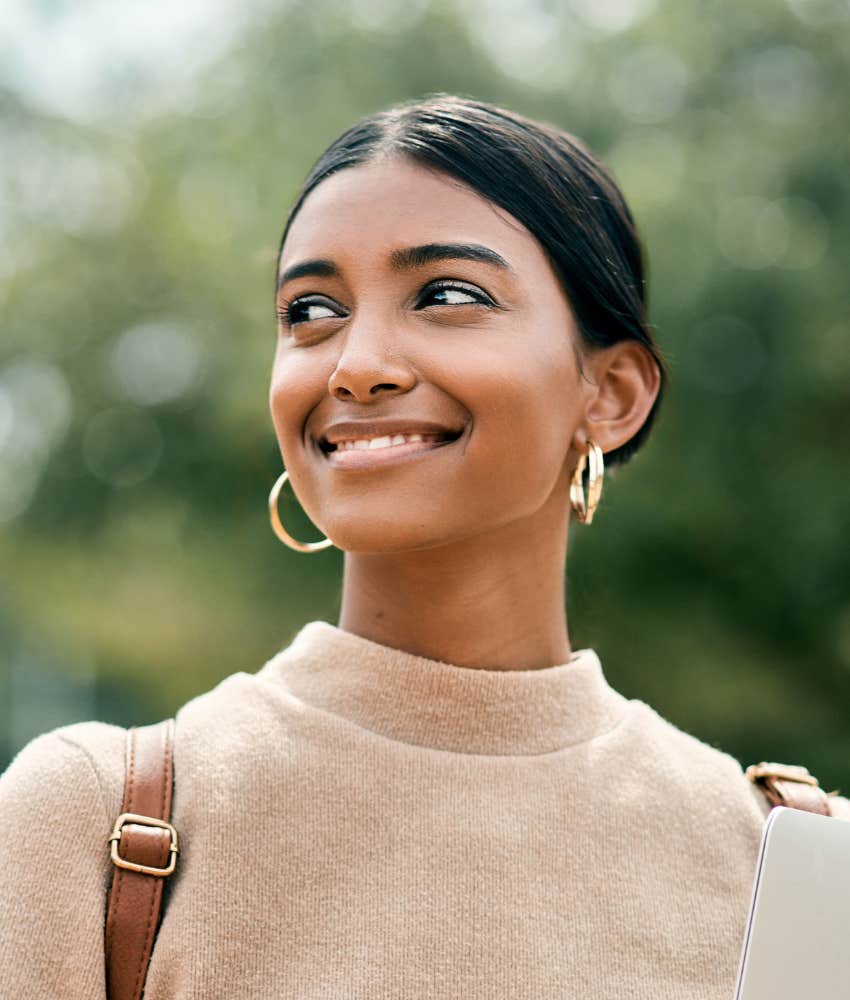 smiling person shifts eyes to the side showing perspective shift can help self worth